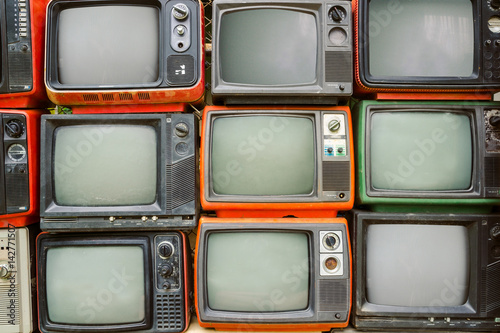 Pattern wall of pile colorful retro television (TV) - vintage filter effect style.