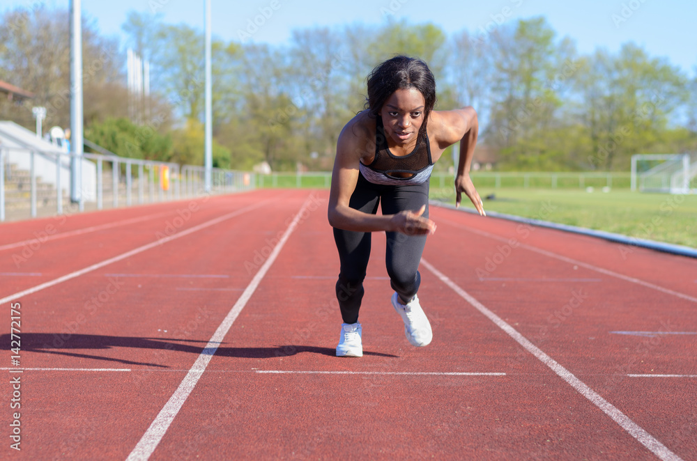 Woman doing sprint training on a sports track