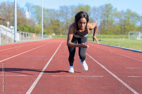 Woman doing sprint training on a sports track