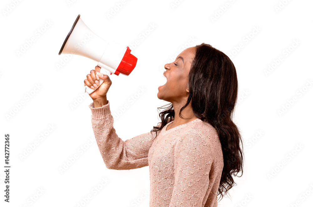 Angry young woman yelling into a megaphone Angry young woman yelling into a megaphone