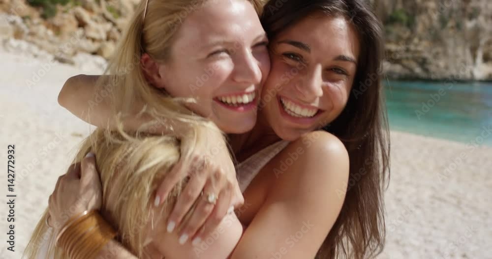 Best friends hugging two cute girl teenagers giving kiss on cheek woman on tropical beach summer vacation Best friends hugging two cute girl teenagers giving kiss on cheek woman on tropical beach summer vacation