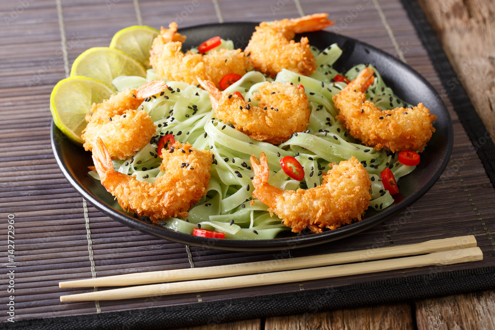 Shrimp tempura with green tea Macha pasta and sesame close-up. horizontal 