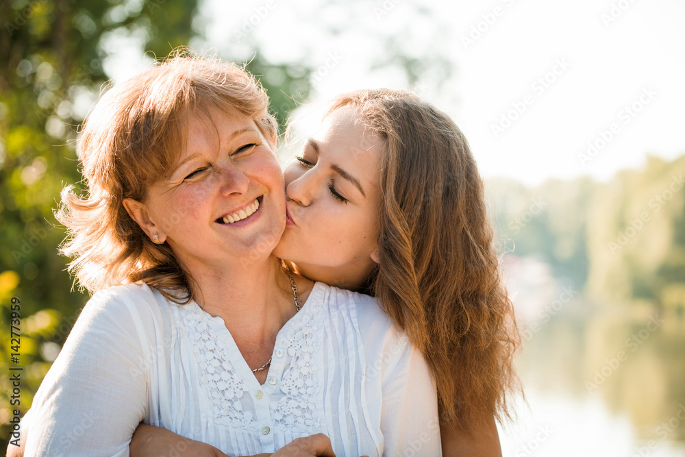 Happy together - mother and teenage daughter outdoor Happy together - mother and teenage daughter outdoor