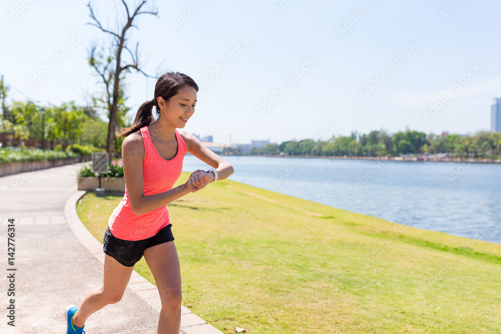 Woman running in green park