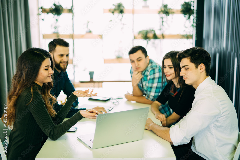 Young group of people discussing business plans.