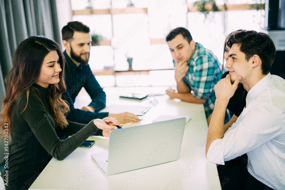 Young group of people discussing business plans. Young group of people discussing business plans.