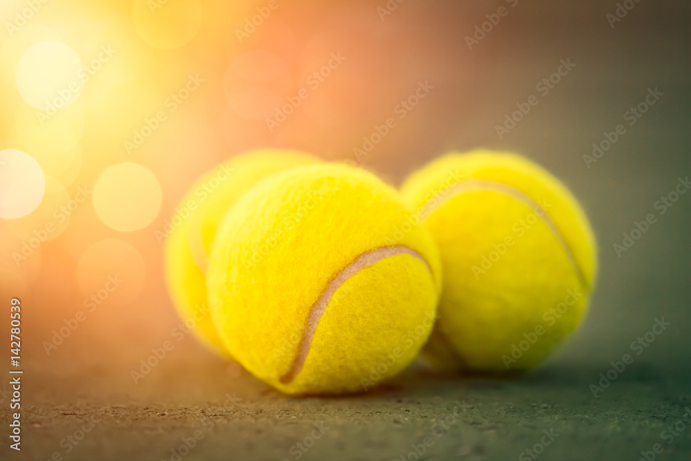 macro three tennis balls on court