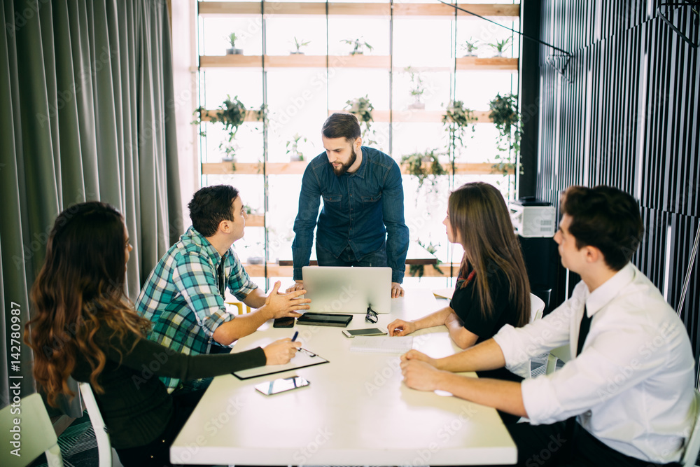 Young group of people discussing business plans. Young group of people discussing business plans.