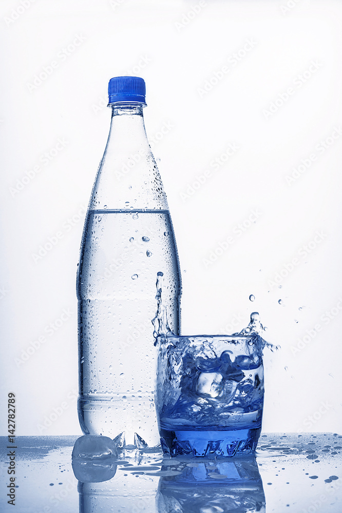 Plastic bottle contains cold water. Bottle covered with water
