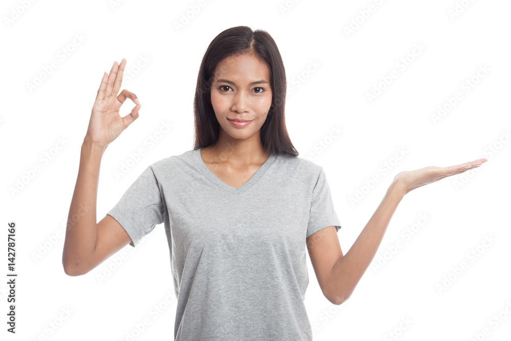 Beautiful young Asian woman show palm hand and OK sign. Beautiful young Asian woman show palm hand and OK sign.