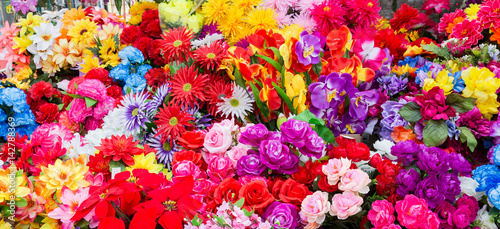 A variety of artificial flowers. Colorful background of flowers