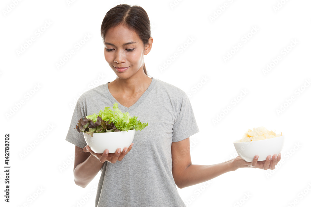 Young Asian woman with potato chips and salad. Young Asian woman with potato chips and salad.
