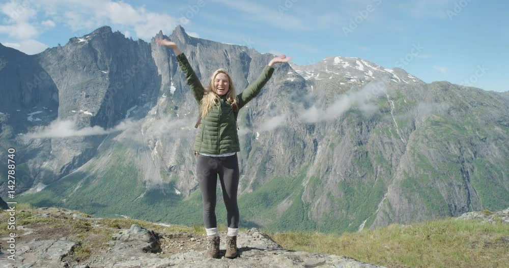 Beautiful woman filming selfie video using smartphone outdoors Independent traveller Vlogger Girl sharing video on social media travel vlog with mobile phone enjoying vacation travel adventure Romsdalen Valley Norway
