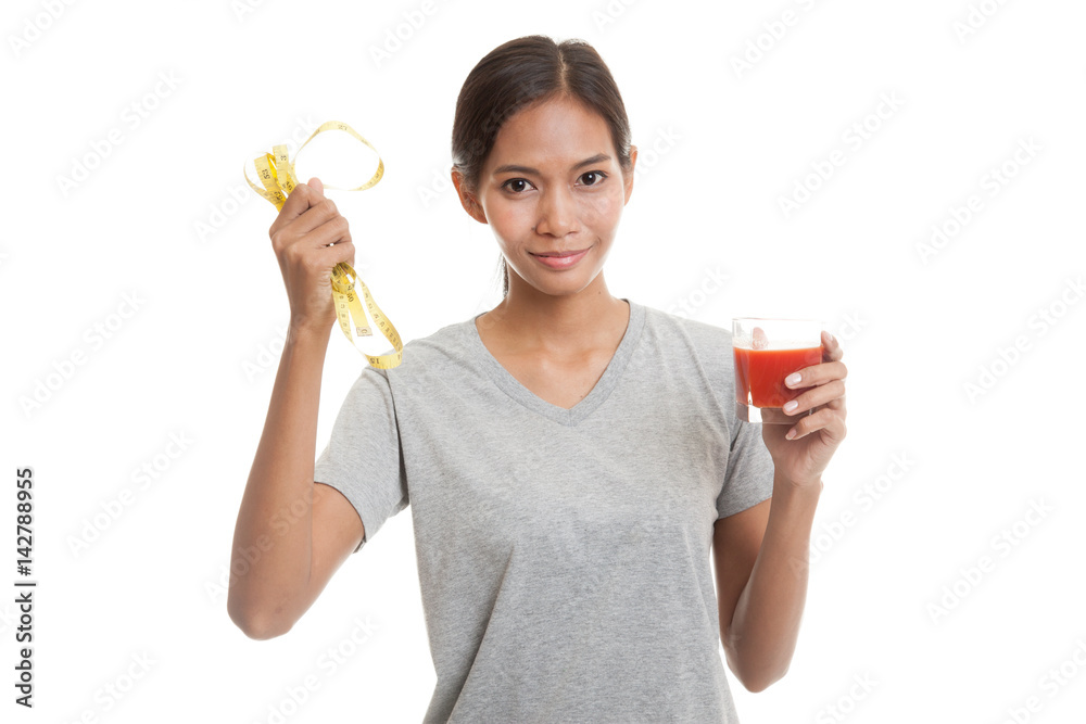 Asian woman with tomato juice and measuring tape. Asian woman with tomato juice and measuring tape.