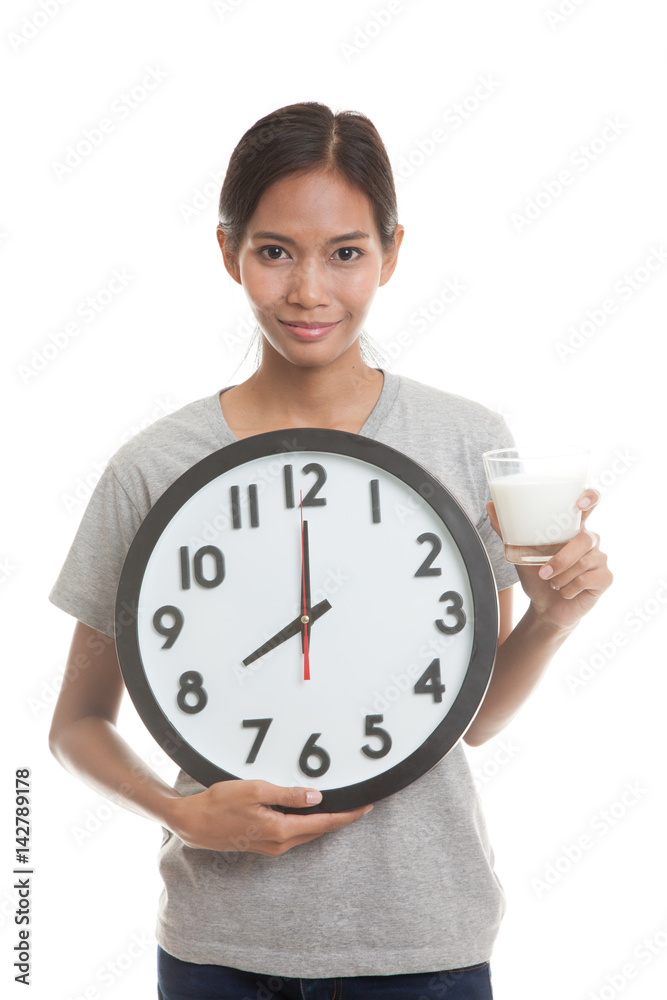 Healthy Asian woman drinking glass of milk hold clock. Healthy Asian woman drinking glass of milk hold clock.