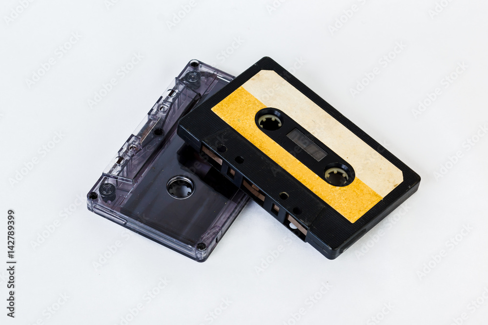 Old audio cassette isolated on white background. Historical records sound on a magnetic tape. Place for your text. Old audio cassette isolated on white background. Historical records sound on a magnetic tape. Place for your text.