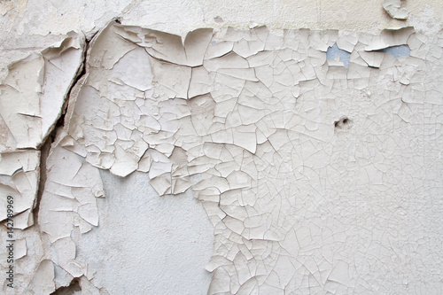 Vintage background texture of old brick masonry on ancient cement with cracks with traces of old paint. photo