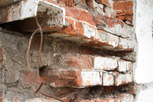 Vintage background texture of old brick masonry on ancient cement with cracks with traces of old paint. photo