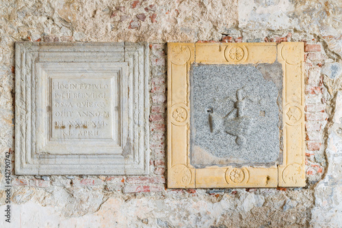 Hermitage of Santa Caterina del Sasso (XIII century) on lake Maggiore, Italy. Detail of two tombstones of the sixteenth century, placed in the portico of the church of St. Catherine