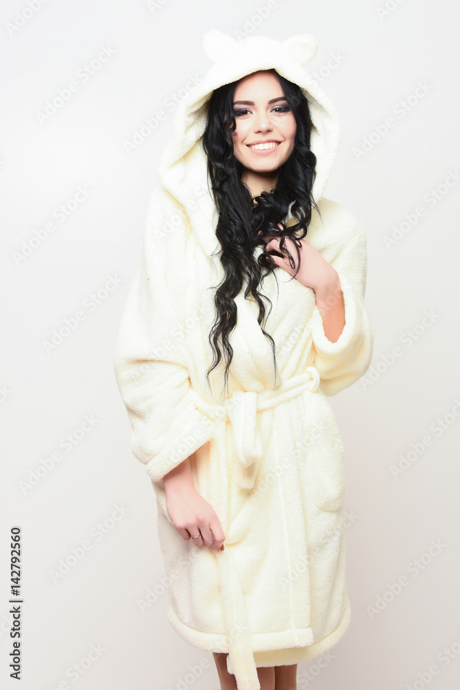 sexy smiling girl posing in beige velour bathrobe sexy smiling girl posing in beige velour bathrobe