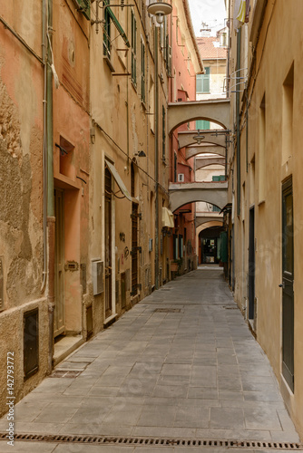 narrow alley in sea village, Finale Ligure, Italy