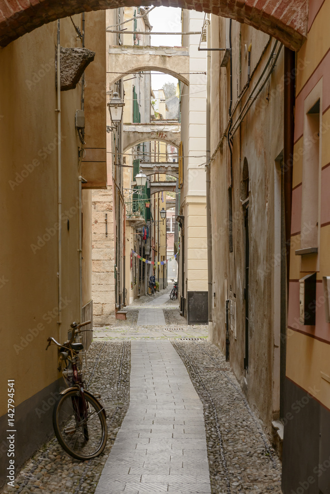 narrow lane in historical village, Finalborgo, Italy