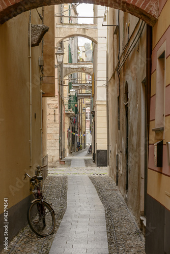 narrow lane in historical village, Finalborgo, Italy