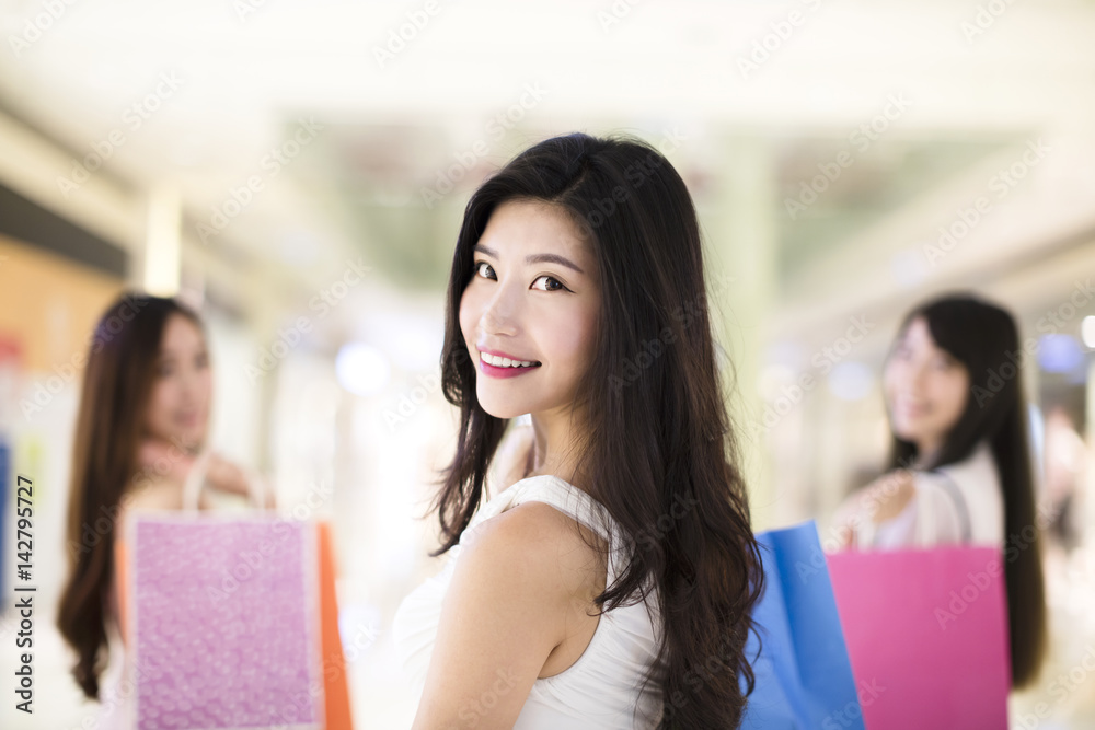 Fototapeta premium happy woman group with shopping bags walking at the mall.