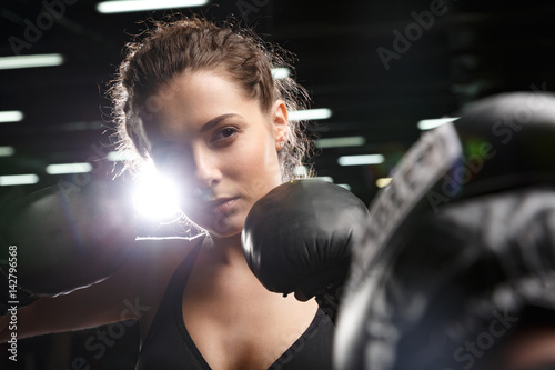 Young strong sports lady boxer standing in gym with man trainer © Drobot Dean