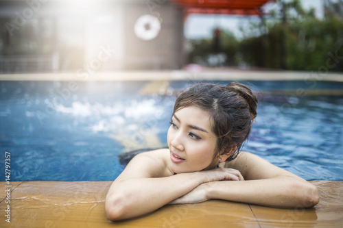 woman relax on a swimming pool.