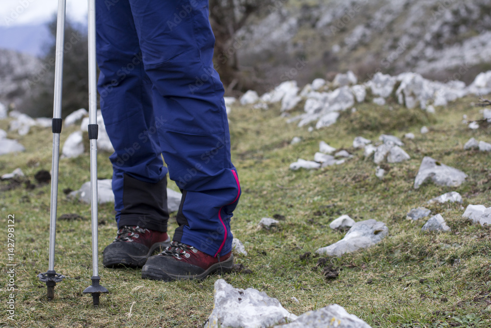 Woman. Hiking poles. Woman. Hiking poles.