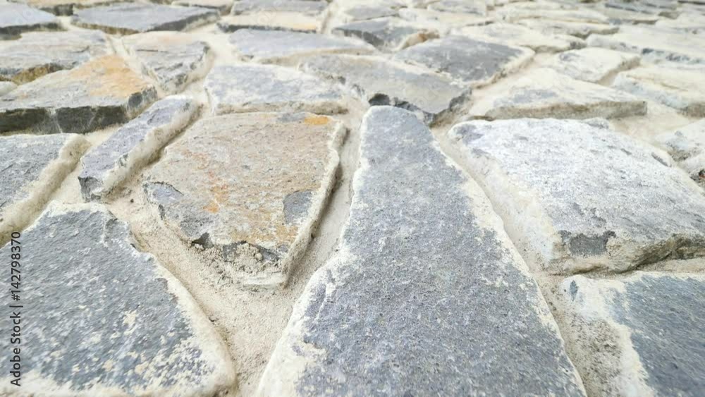 Building wall built from broken flat stones. Old stony wall from nature material and concrete, broken marl stones , traditional building materials. Building wall built from broken flat stones. Old stony wall from nature material and concrete, broken marl stones , traditional building materials.