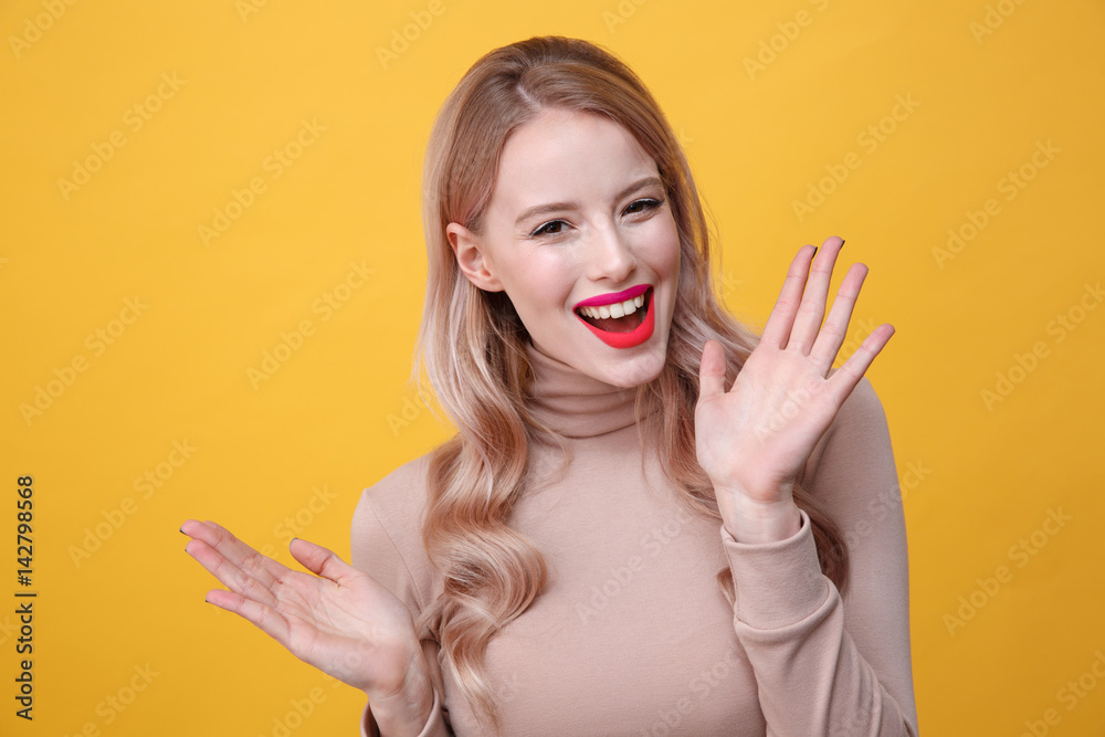 Cheerful young blonde lady with bright makeup lips