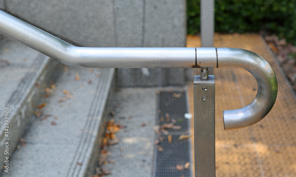 a metal railing in public park a metal railing in public park