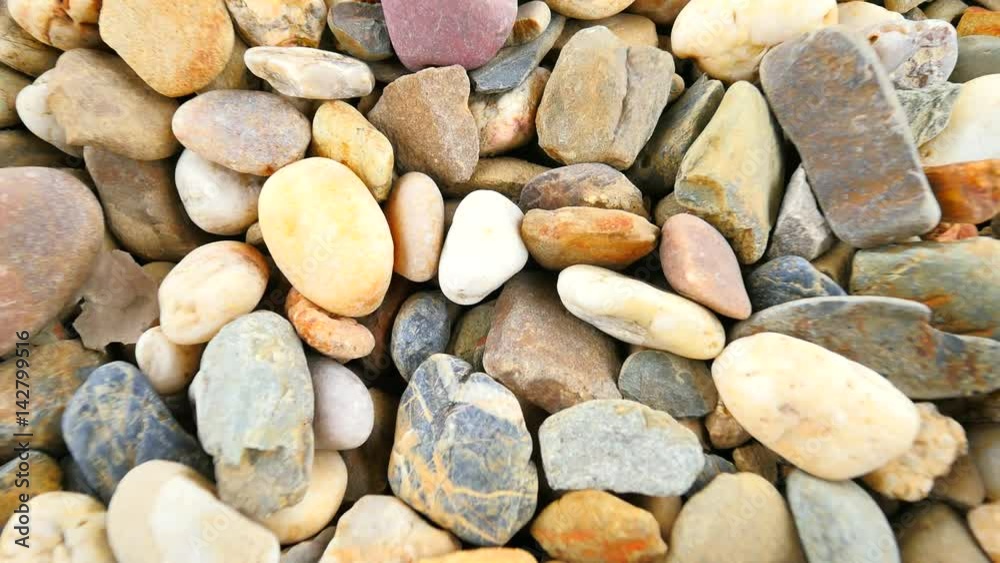 Old stony pavement from natural gravel, dry rounded stones, Traditional building materials, small colorful pebbles. Camera moving close up to ground. Old stony pavement from natural gravel, dry rounded stones, Traditional building materials, small colorful pebbles. Camera moving close up to ground.