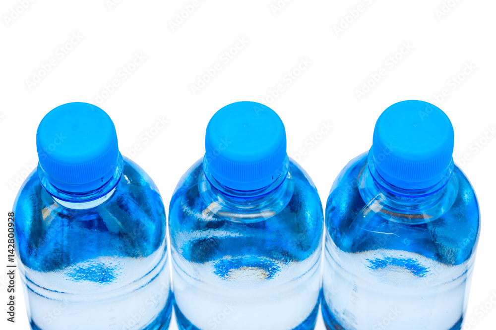 water in plastic bottles on a white water in plastic bottles on a white