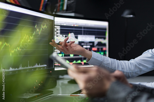 Obraz na plátně Analyzing graphs and reports for investment purposes