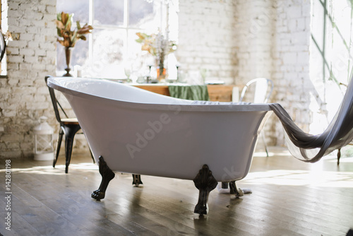 Interior of a vintage bathroom with freestanding bathtub