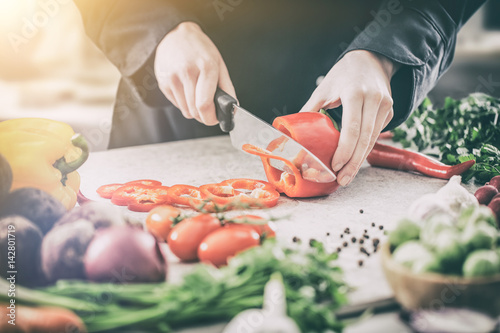 The chef slicing vegetables.