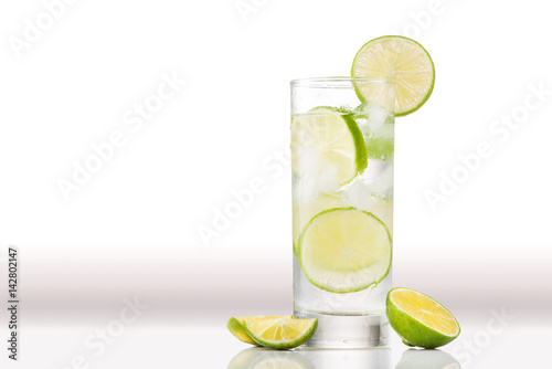 Full glass of water with lemon and mint isolated on white background