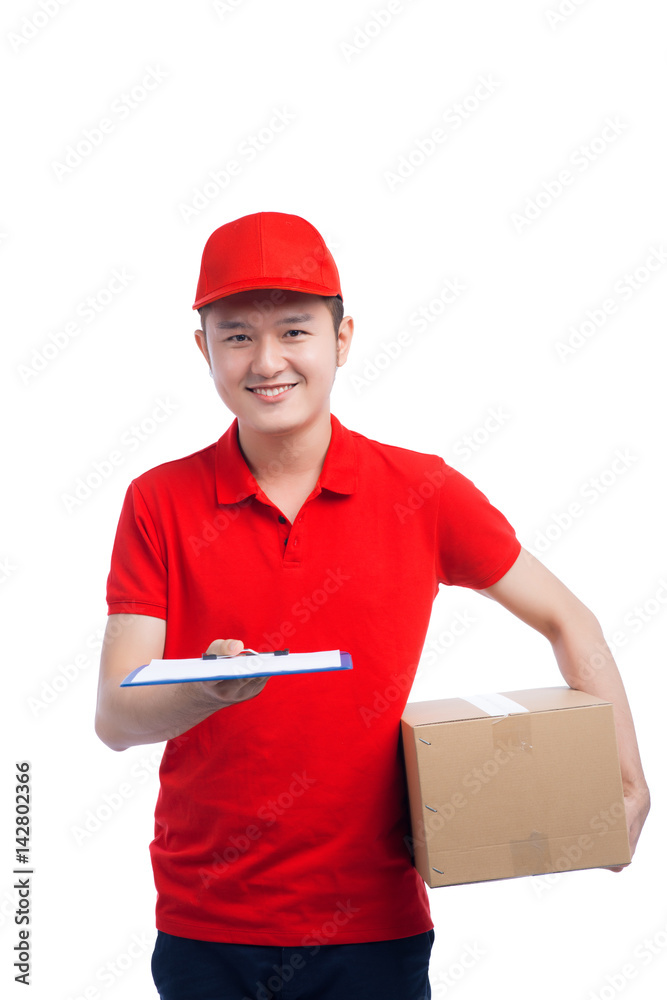 Handsome young worker in red t-shirt and cap smiling, holding a folder and making notes, on white background Handsome young worker in red t-shirt and cap smiling, holding a folder and making notes, on white background