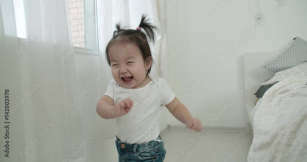 slow motion, a little girl runs in the room during the game and very emotionally happy slow motion, a little girl runs in the room during the game and very emotionally happy