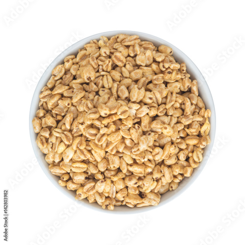 Heap of Puffed Wheat Snack in White Round Bowl Isolated