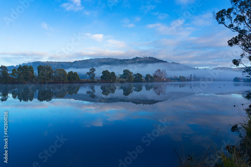 Beautiful river landscape on calm day photo