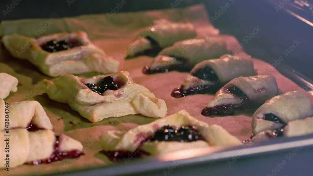 Croissants and bagels with cherries are baked in the Oven Croissants and bagels with cherries are baked in the Oven