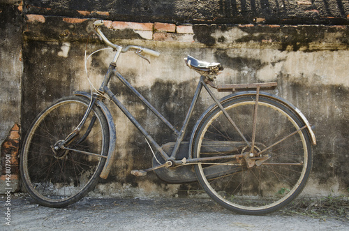 Vintage old classic bicycle against stop at the wall