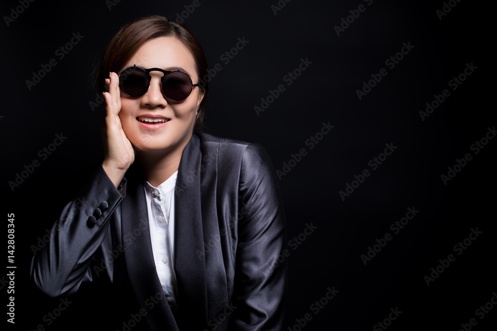 Happy businesswoman wearing sun glasses on isolated background Happy businesswoman wearing sun glasses on isolated background