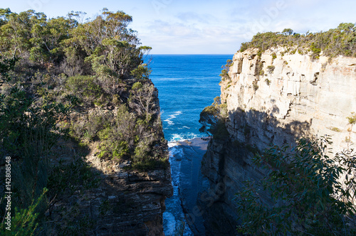 Narrow ocean passage, path among high cliffs, mountains