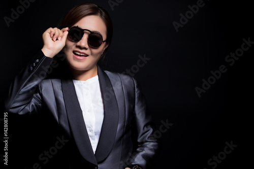 Happy businesswoman wearing sun glasses on isolated background