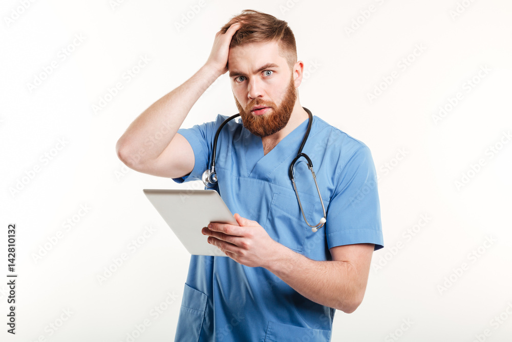 Portrait of a surprised young doctor in blue uniform Portrait of a surprised young doctor in blue uniform